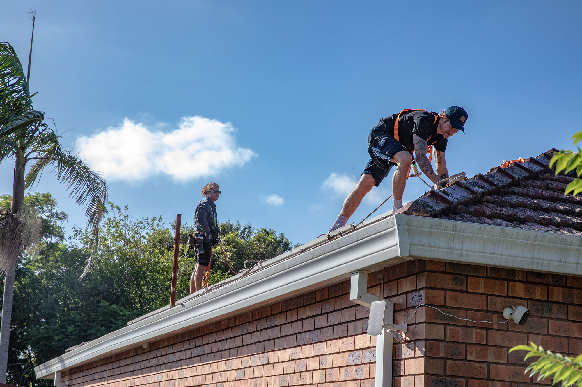 Solar installers working on a rooftop